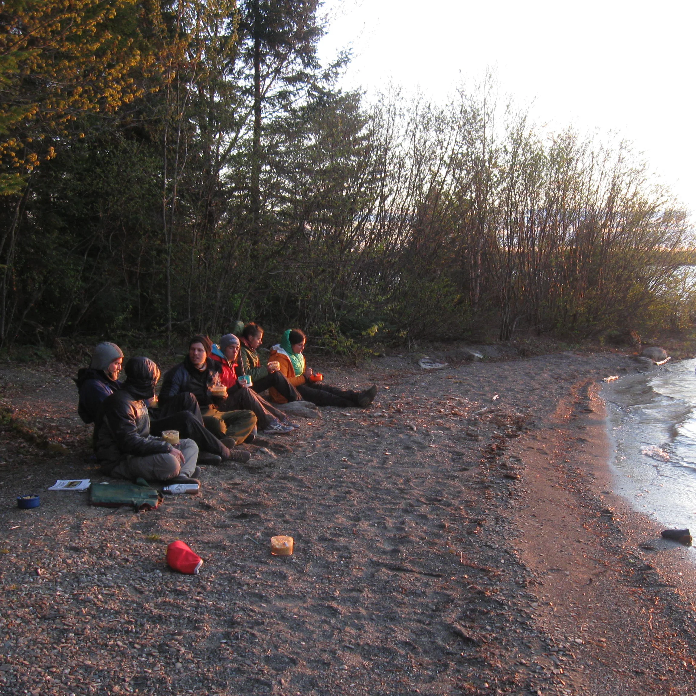 An Early Afternoon at Camp We will all help unload the canoes and bring them on shore for their night of rest. Tonight's place of rest, like all on this trip, is a maintained campsite. Although rustic and only accessible by canoe, we find picnic tables, cleared areas for tents, a fire ring, and an outhouse. The guides will begin to set up camp and prep for dinner. The afternoon is often a nice time to take a dip before changing into warmer clothes for the evening. Depending on your trip and its theme, the afternoon may offer a chance to paint, discuss a shared reading, or write in your journal. Whatever is planned, you are sure to have time to relax and enjoy your surroundings with a group of like-minded people. A nice snack of cheese, crackers, cut vegetables and cured meats will energize your thinking and creating.