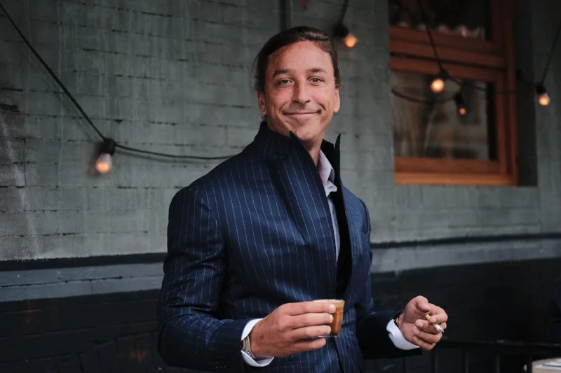 I don't understand AT ALL why this dude shows up as a teacher but he seems happy with his cigarette and what's that a White Russian shot??? Maybe he is on break. 