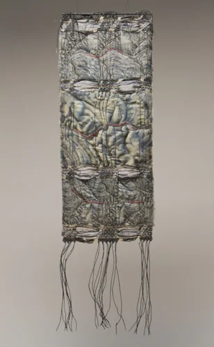 LAVAfolds #3, 2017, H 34” x W 9.5”, linen yarns, silk and cotton fabric, wood and paint; weaving, photographic transfer, quilting, embroidery Photography credit: Andrew Neuhart