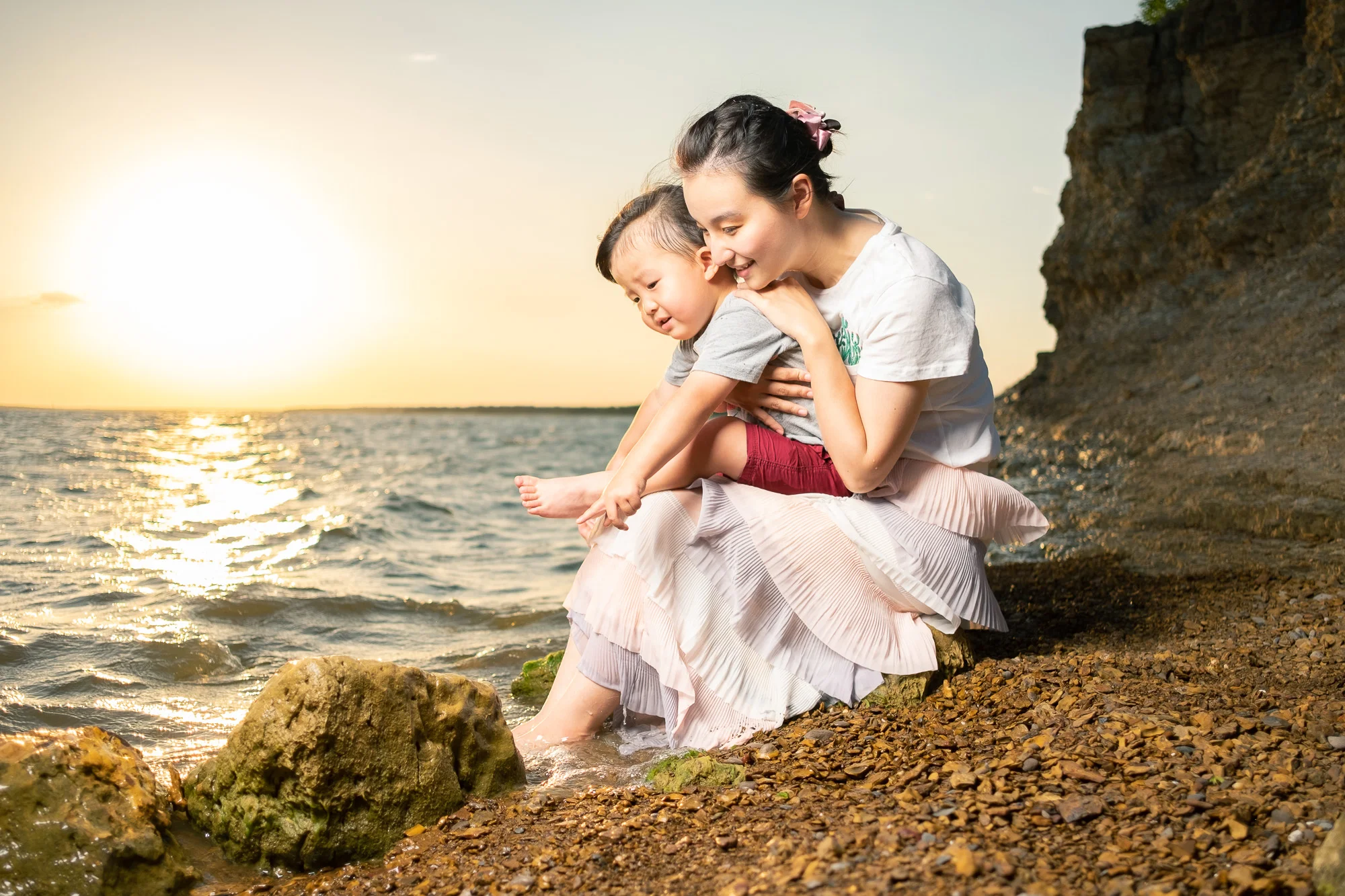 family mother mom son boy child children kid portrait ellicia photos photo shoot beach rocks pebbles water wave sun sunset warm light lighting backlite studio flash on location afternnon love lovely bonding happy.jpg