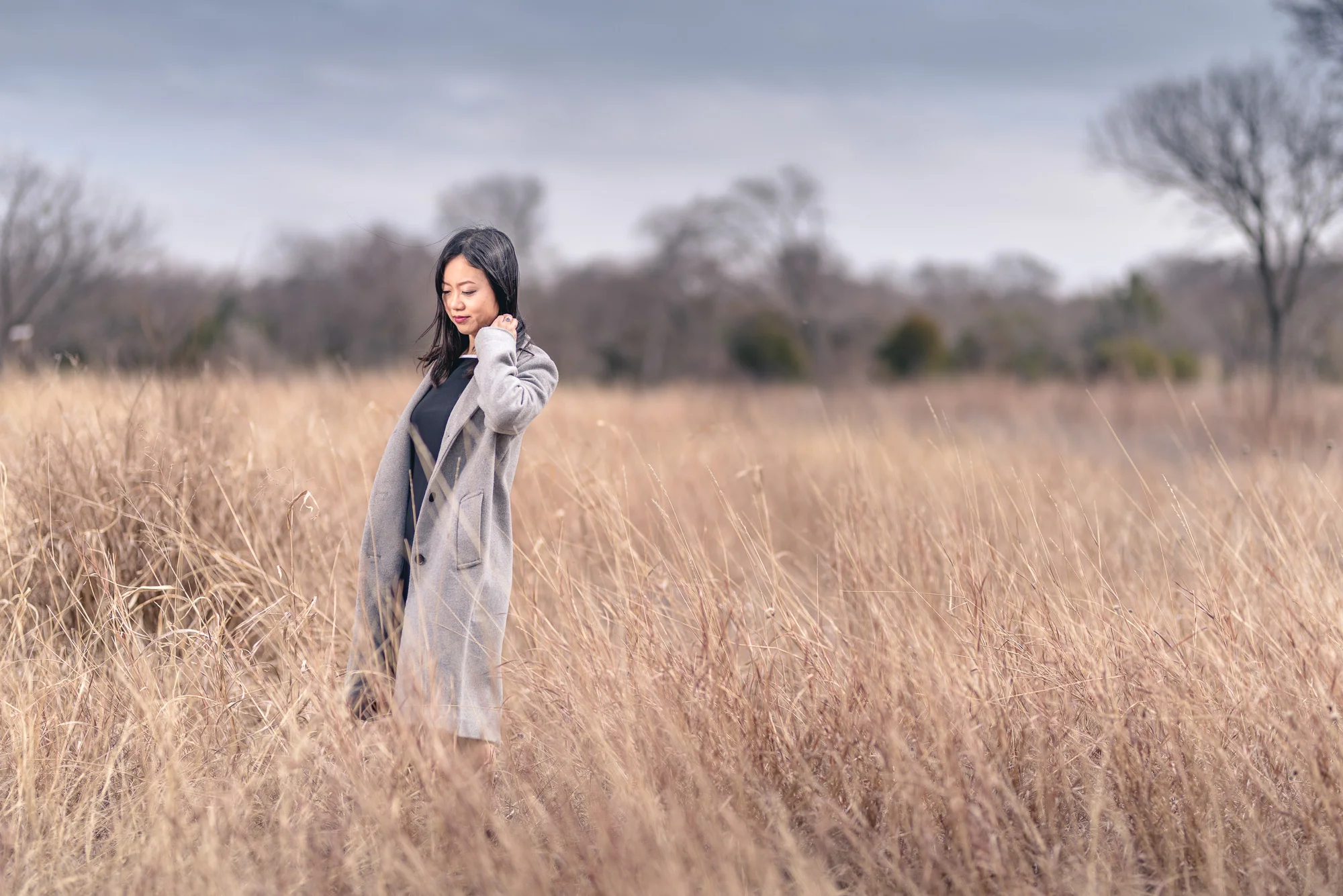 environmental portrait photo shoot ellicia photos fall female girl woman moody yellow grass dark sky flash on location dynamic dramtic lighting long coat cider hill state park elegent cold color tone arlington.jpg
