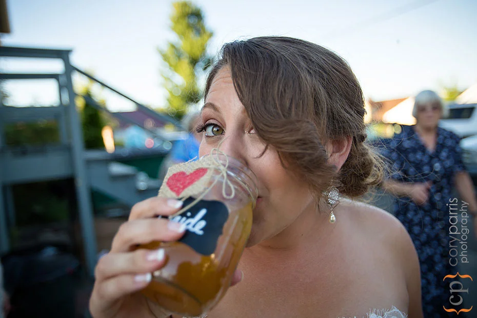 bride drinking out of a mason jar