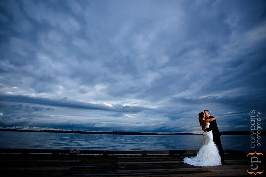bride and groom on a dock by Woodmark Hotel using strobist techniqes