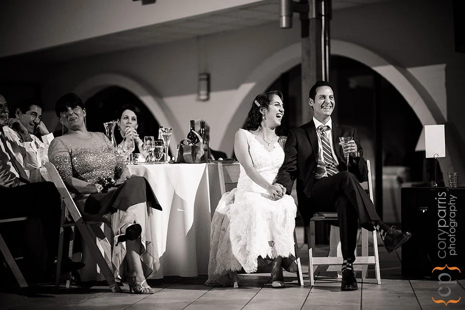 wedding couple laughing at toasts