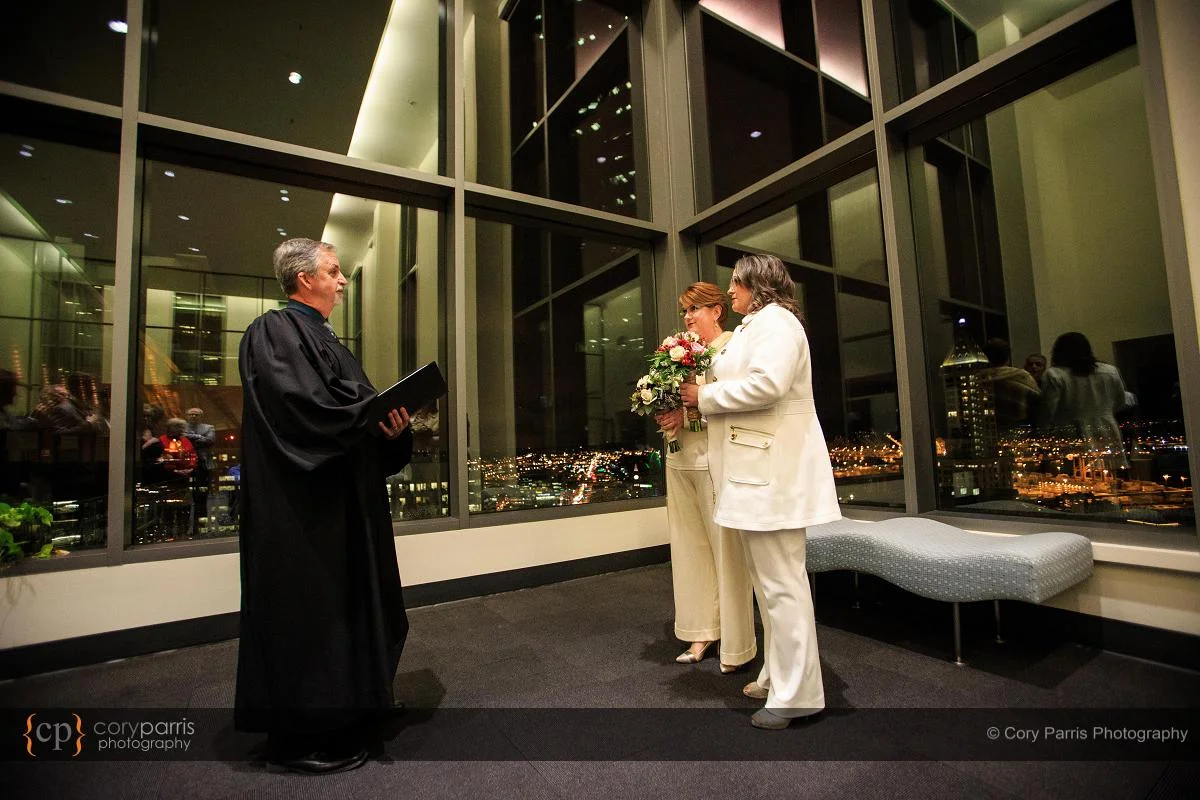 wedding ceremony with the city lights in the background.