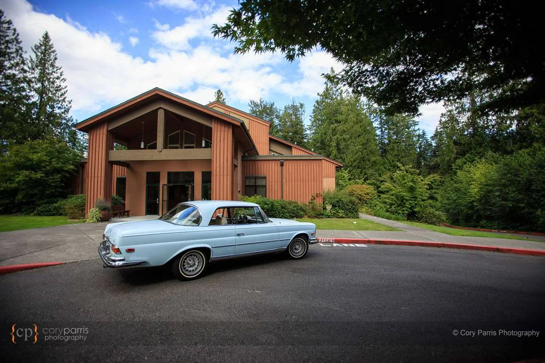 Classic baby blue Mercedes in front of the church.