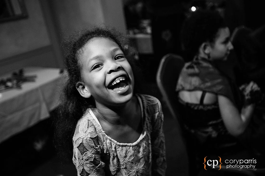 Kid laughing at a wedding reception