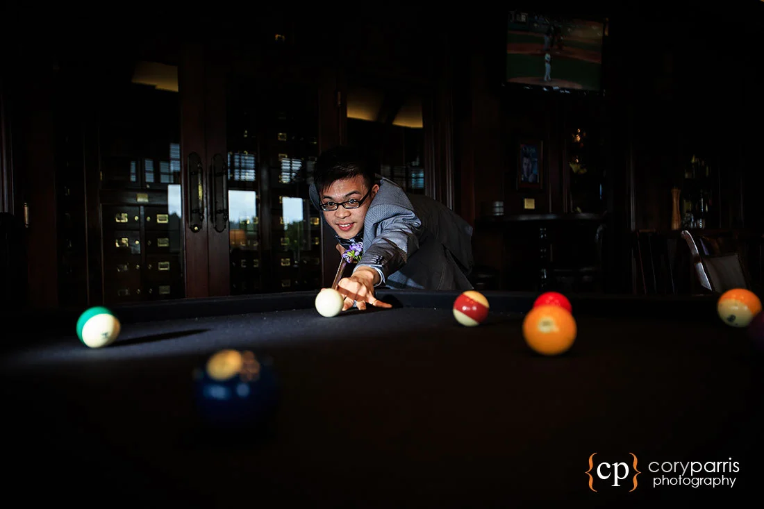 Groom playing pool in the Wooly Toad at the Golf Club at Newcastle