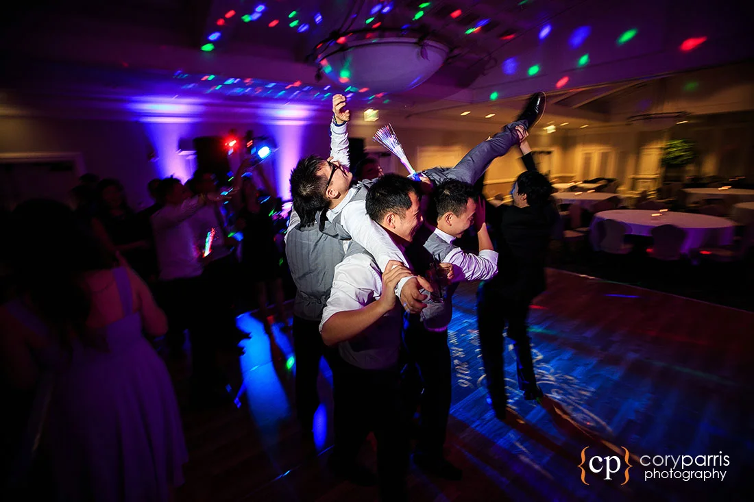 Groom getting carried through the dance floor