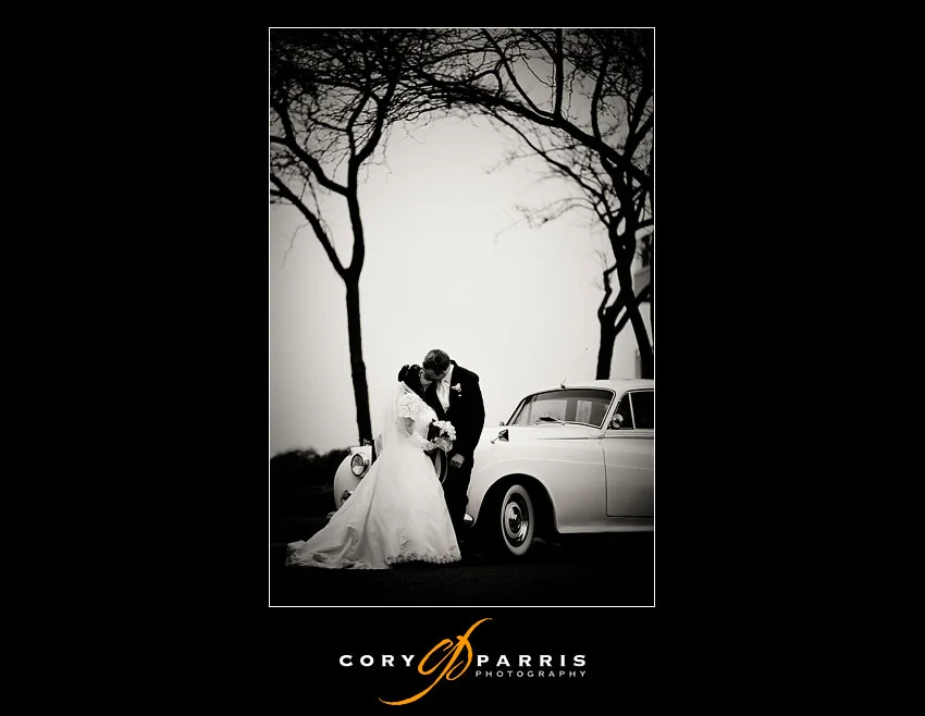 Bride and groom with the rolls royce in the fog