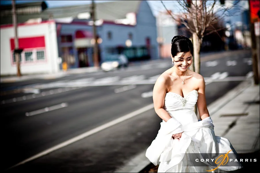 bride standing on the street waiting for her chariot...er...car