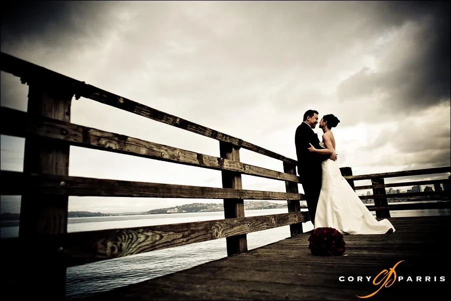 bride and groom on a dock on the seattle waterfront near alki beach