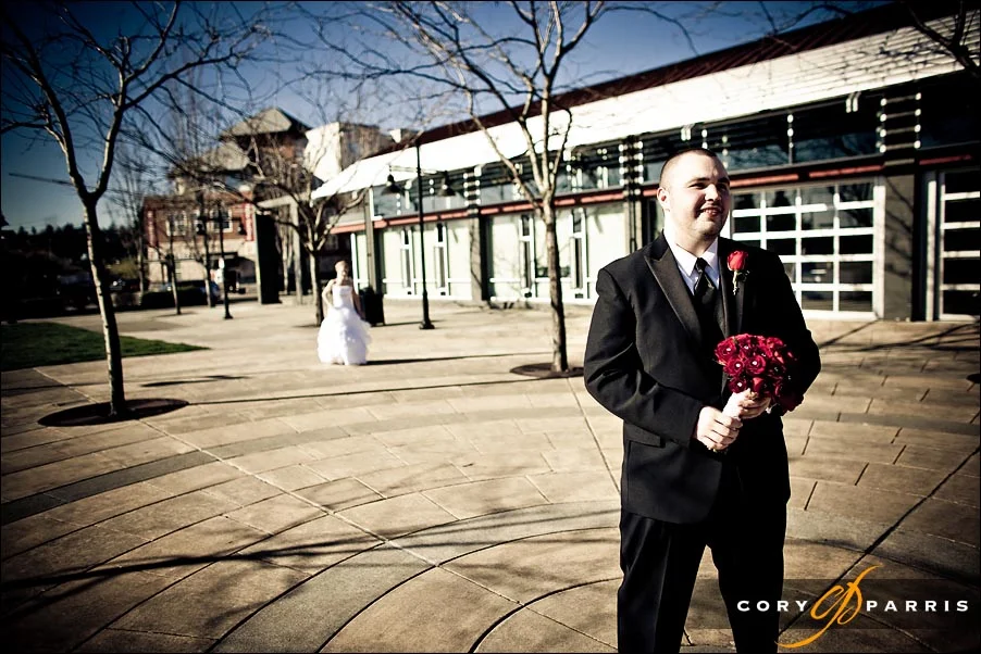 groom waiting with the bride walking up behind him