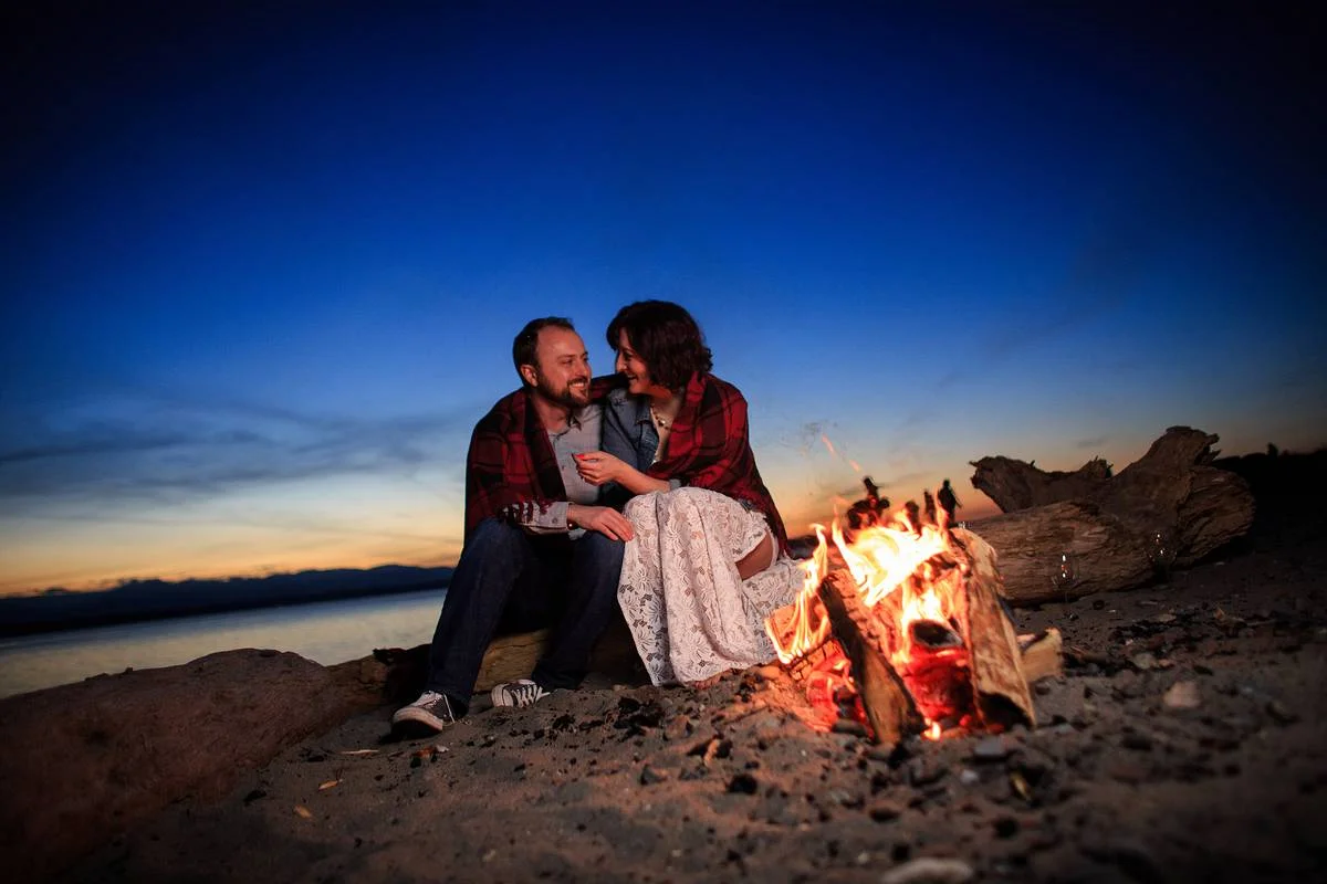 Beach fire sunset couple at Golden Gardens