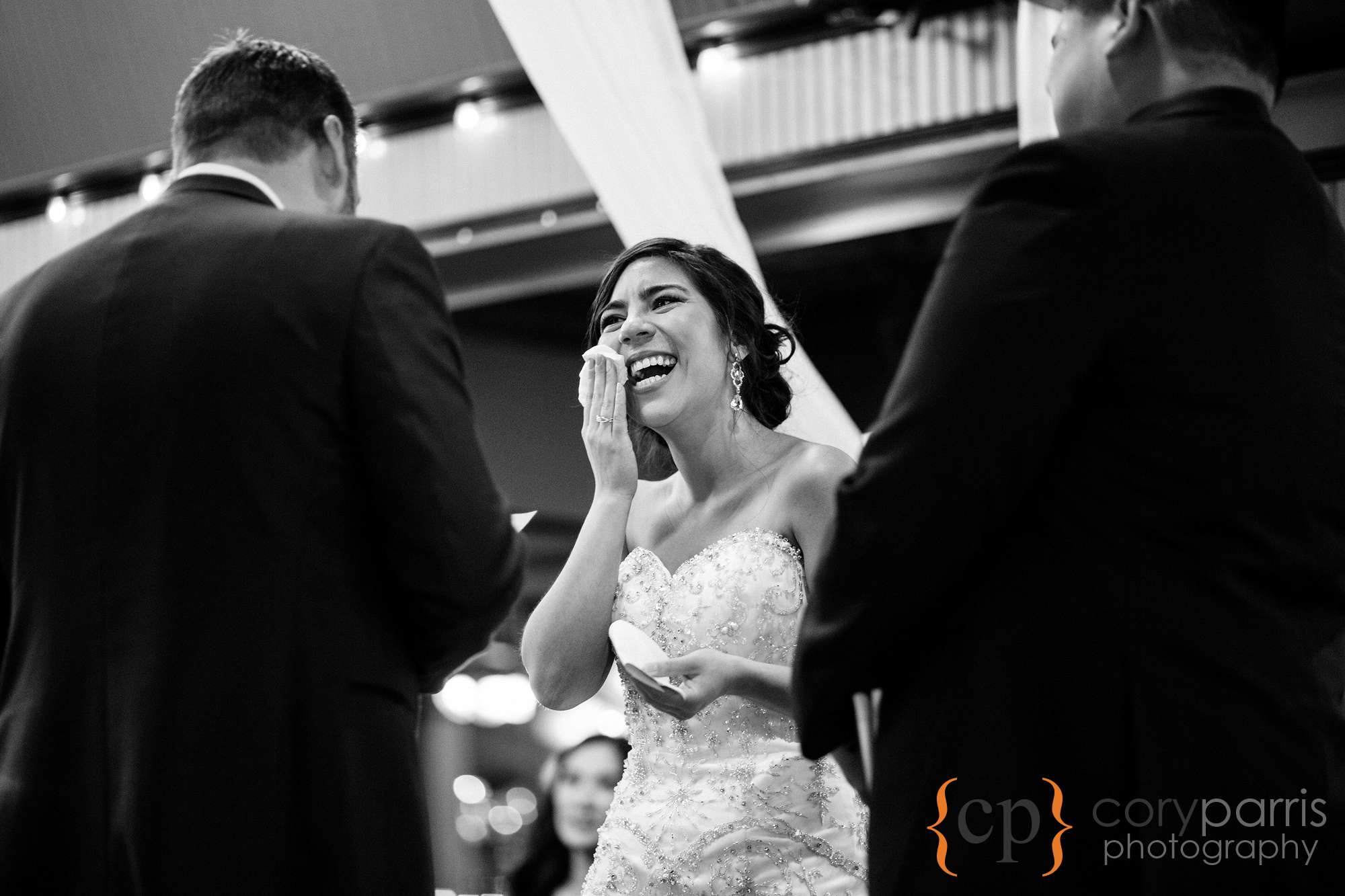 Bride laughing and crying during wedding