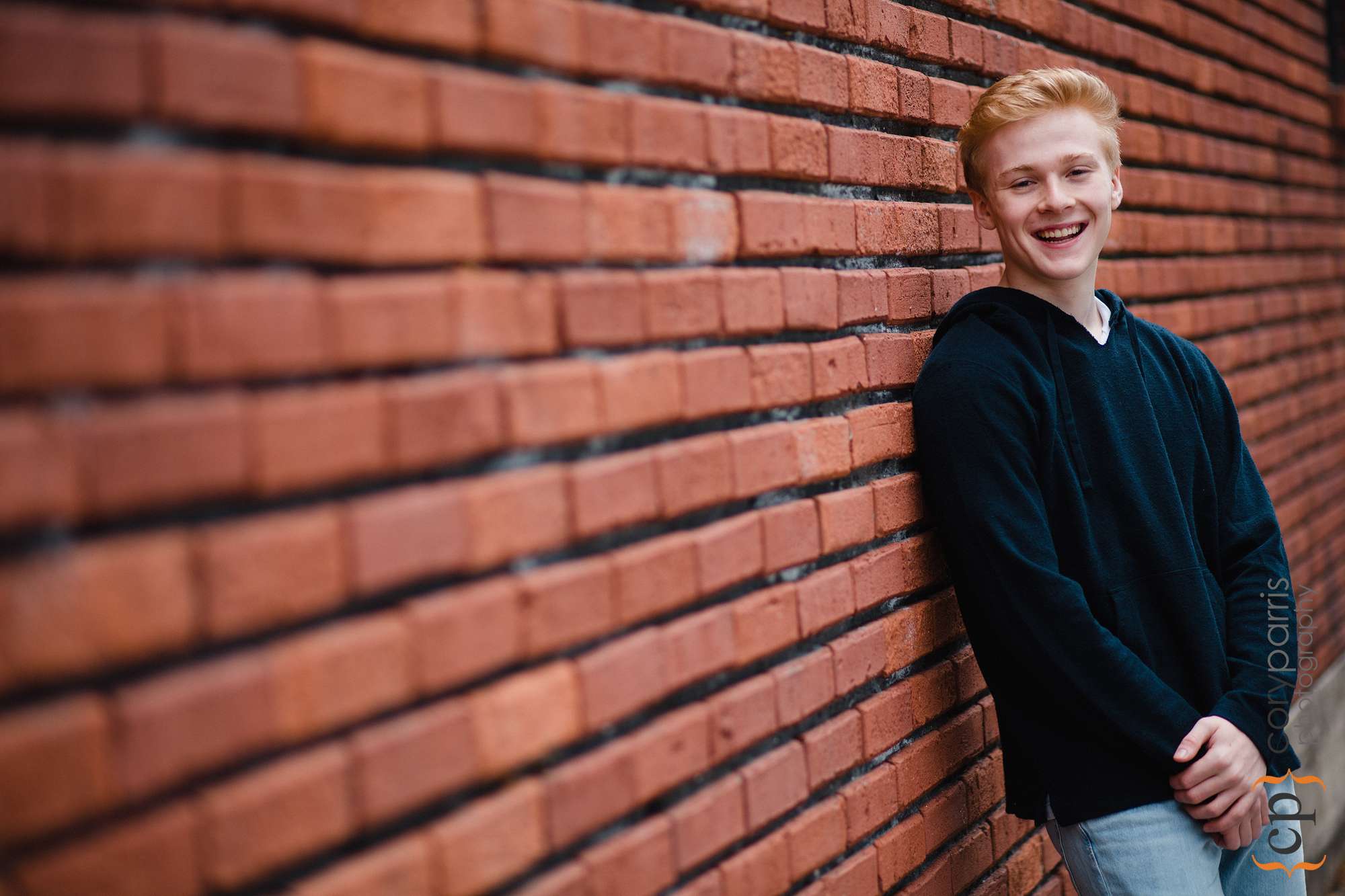 senior portrait with brick wall in seattle