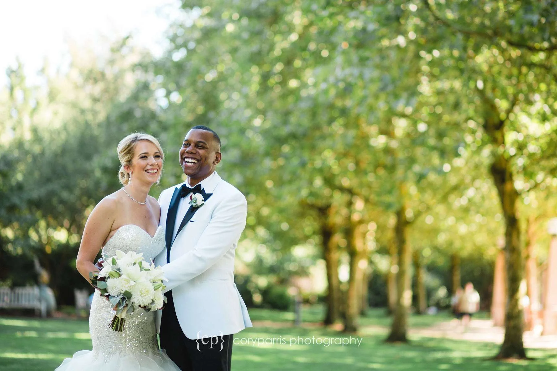 Jen and Marcus laughing together during photographs at the Bellevue Downtown Park before their weddng at the Bellevue Club. 