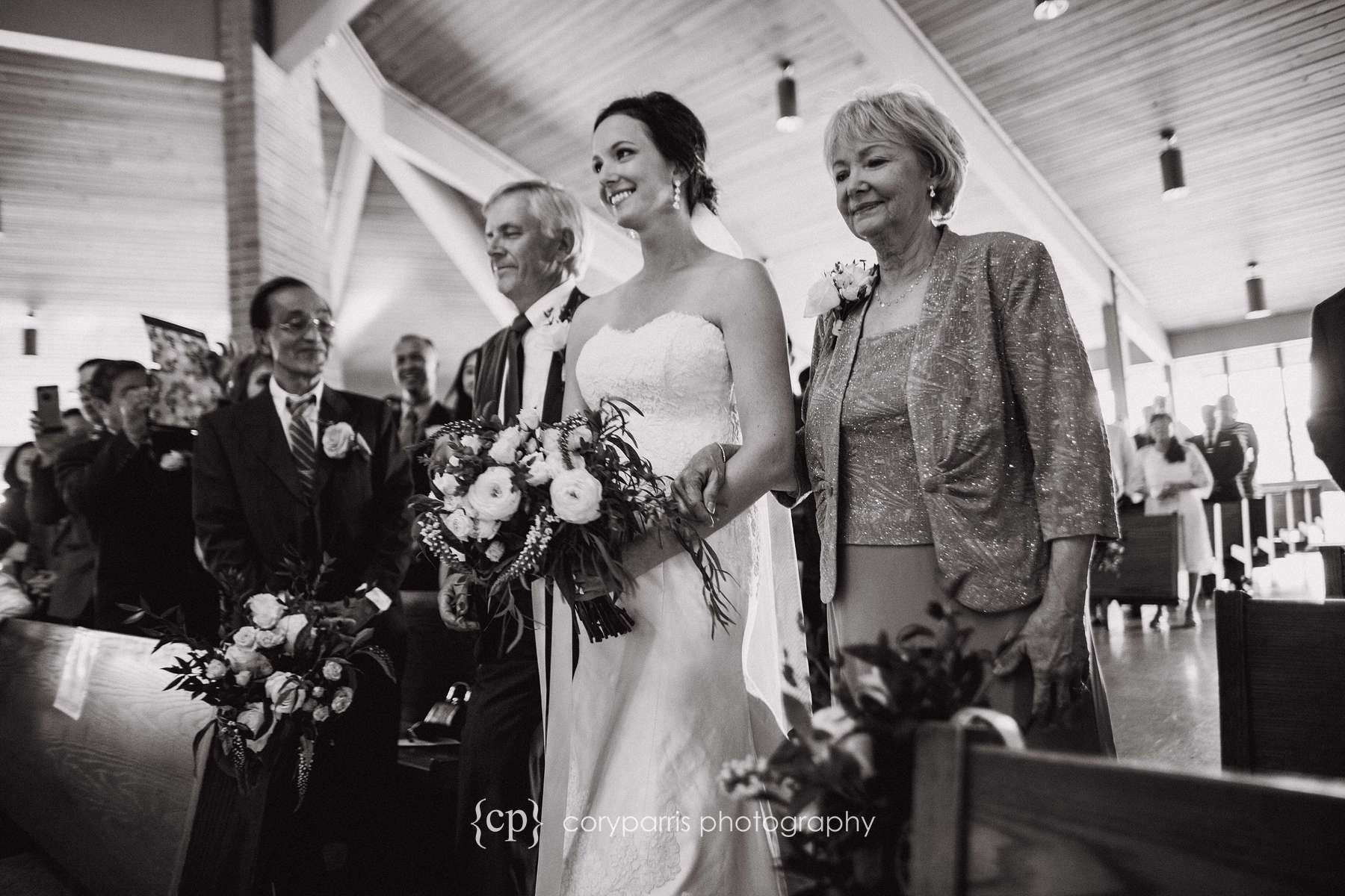  Angie walking down the aisle with her parents before the wedding. 