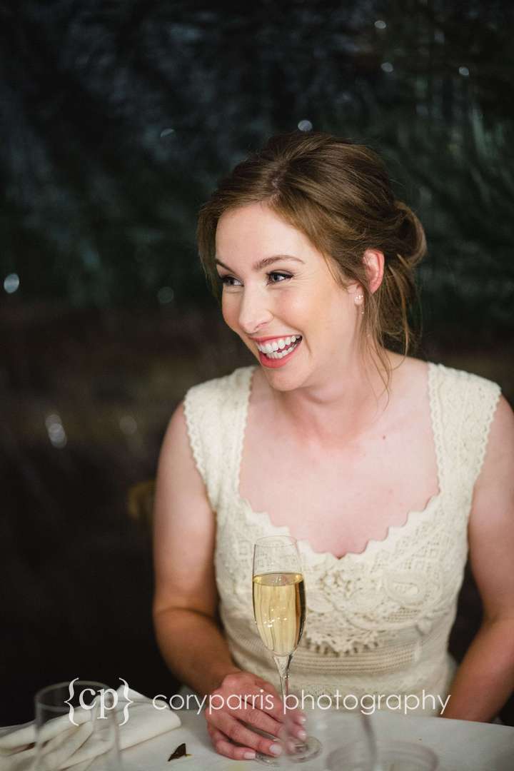 Bride laughing at toasts during her DeLille Cellars wedding reception
