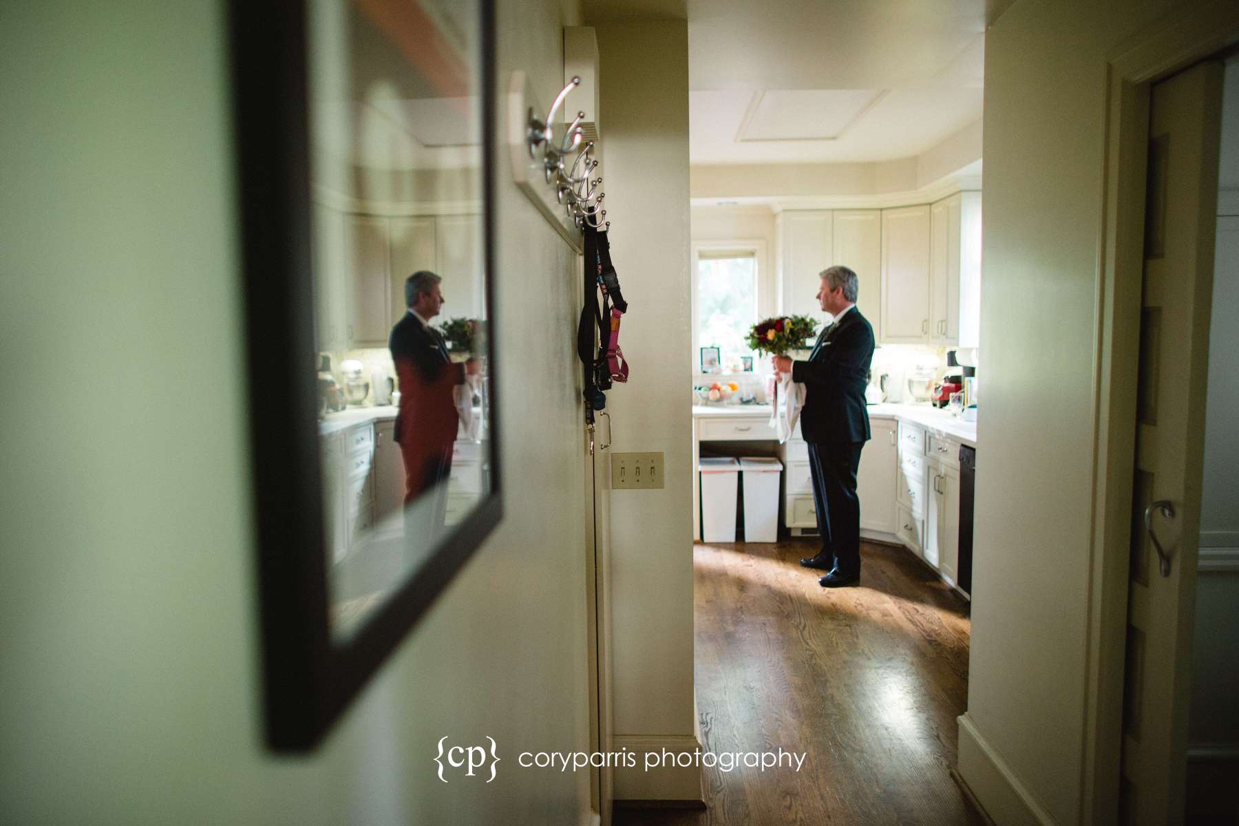 Father of the bride waiting in the kitchen with the flowers