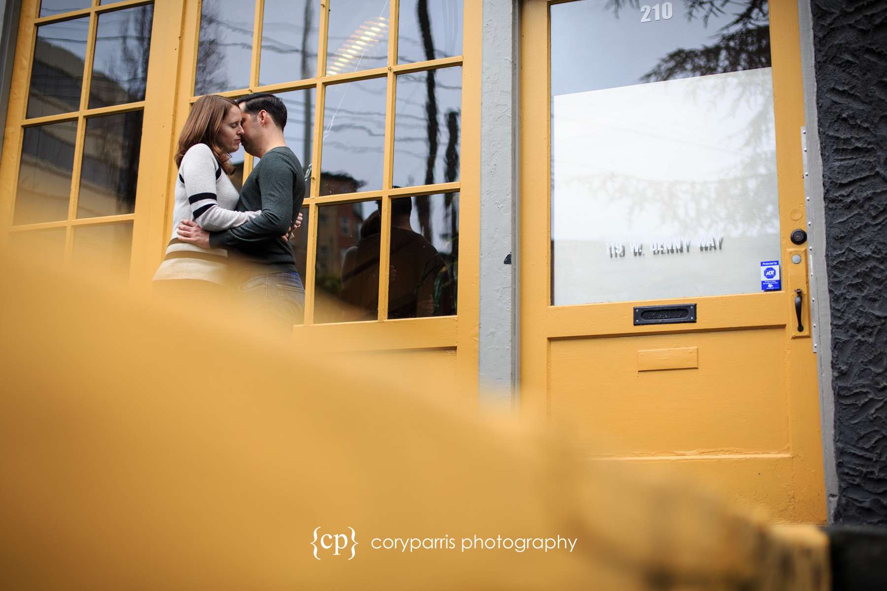 Romantic engagement portrait in Seattle with yellow door