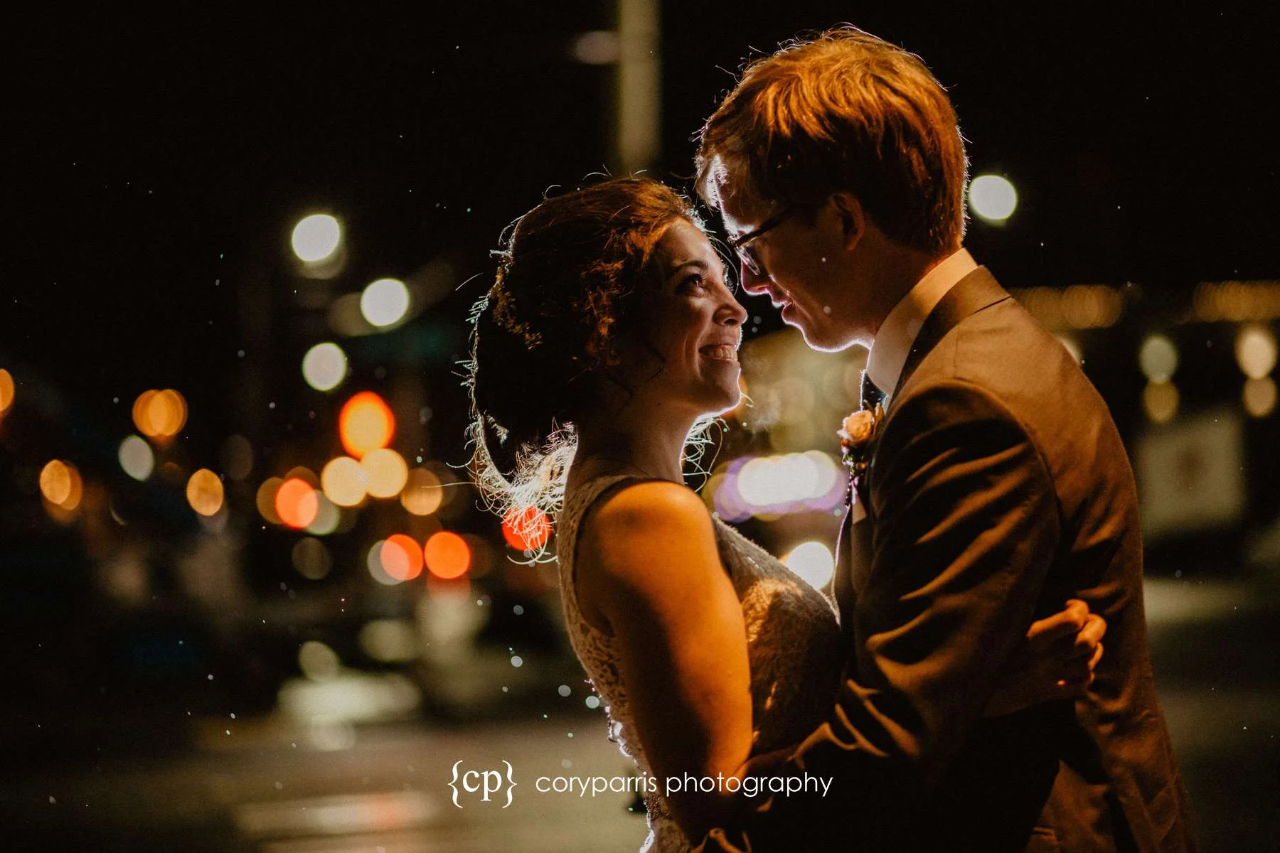 A late night portrait of Amy & Kevin on the rainy streets of Seattle outside of their SODO Park wedding reception.