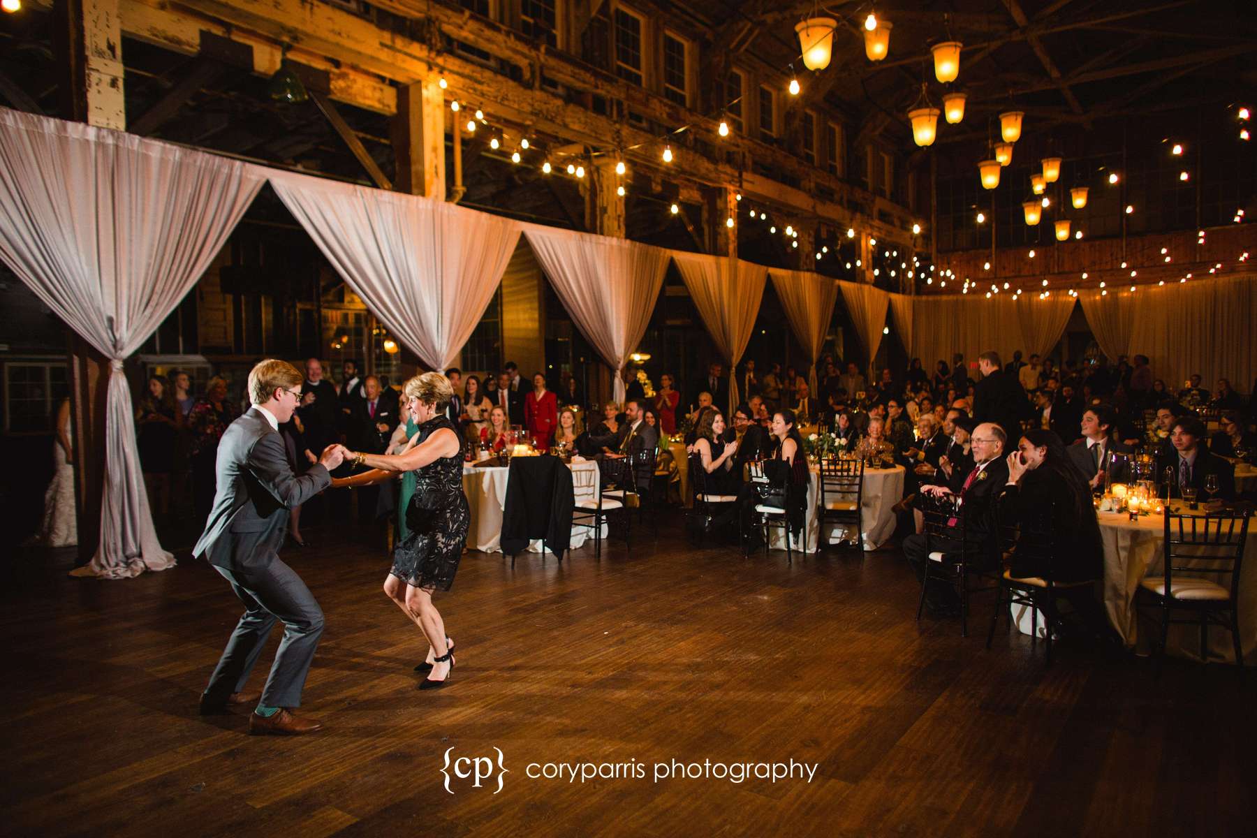 Groom and his mother dancing with the beautiful SODO Park in view