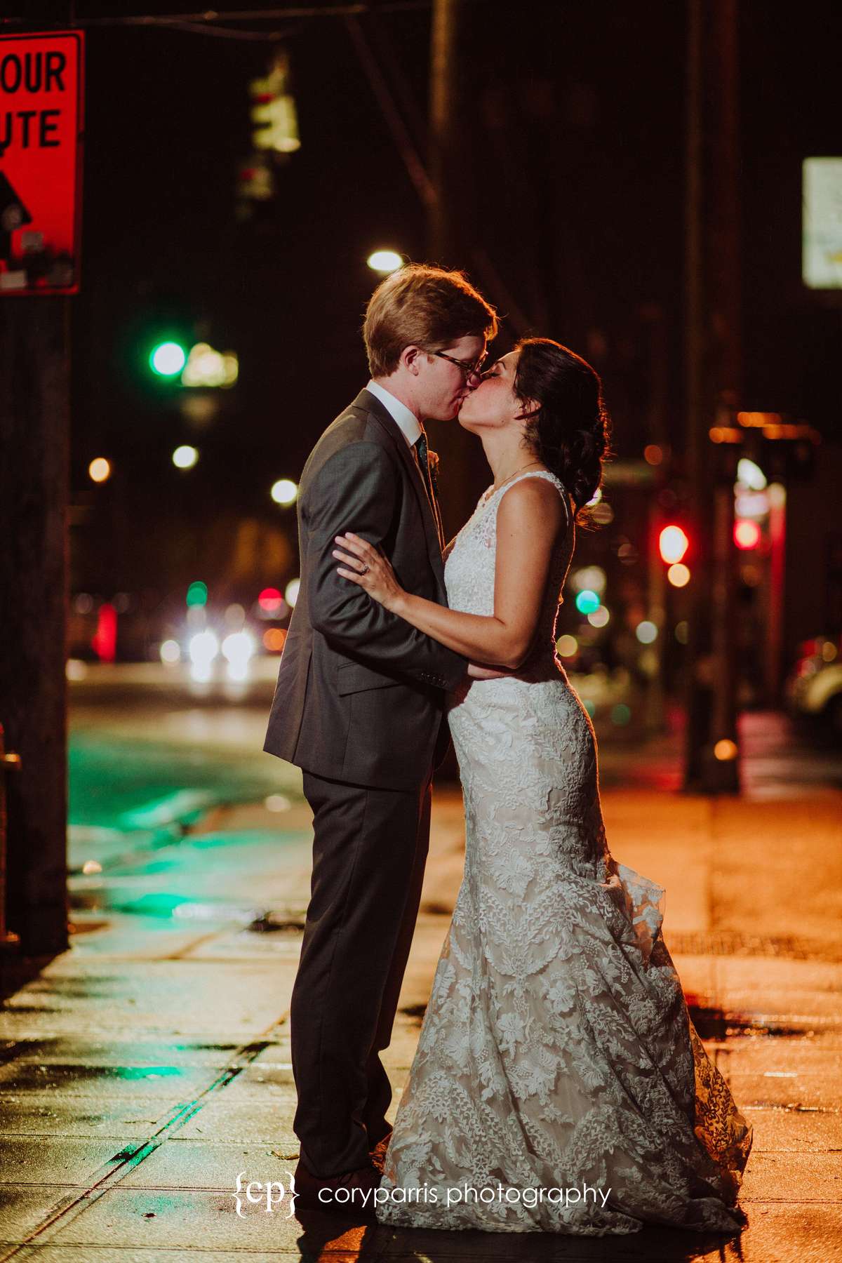 Bride and groom portrait at night on the wet streets of Seattle