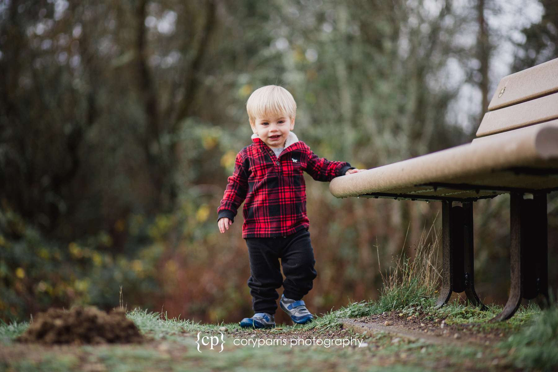 Little boy walking along a bench portrait photography