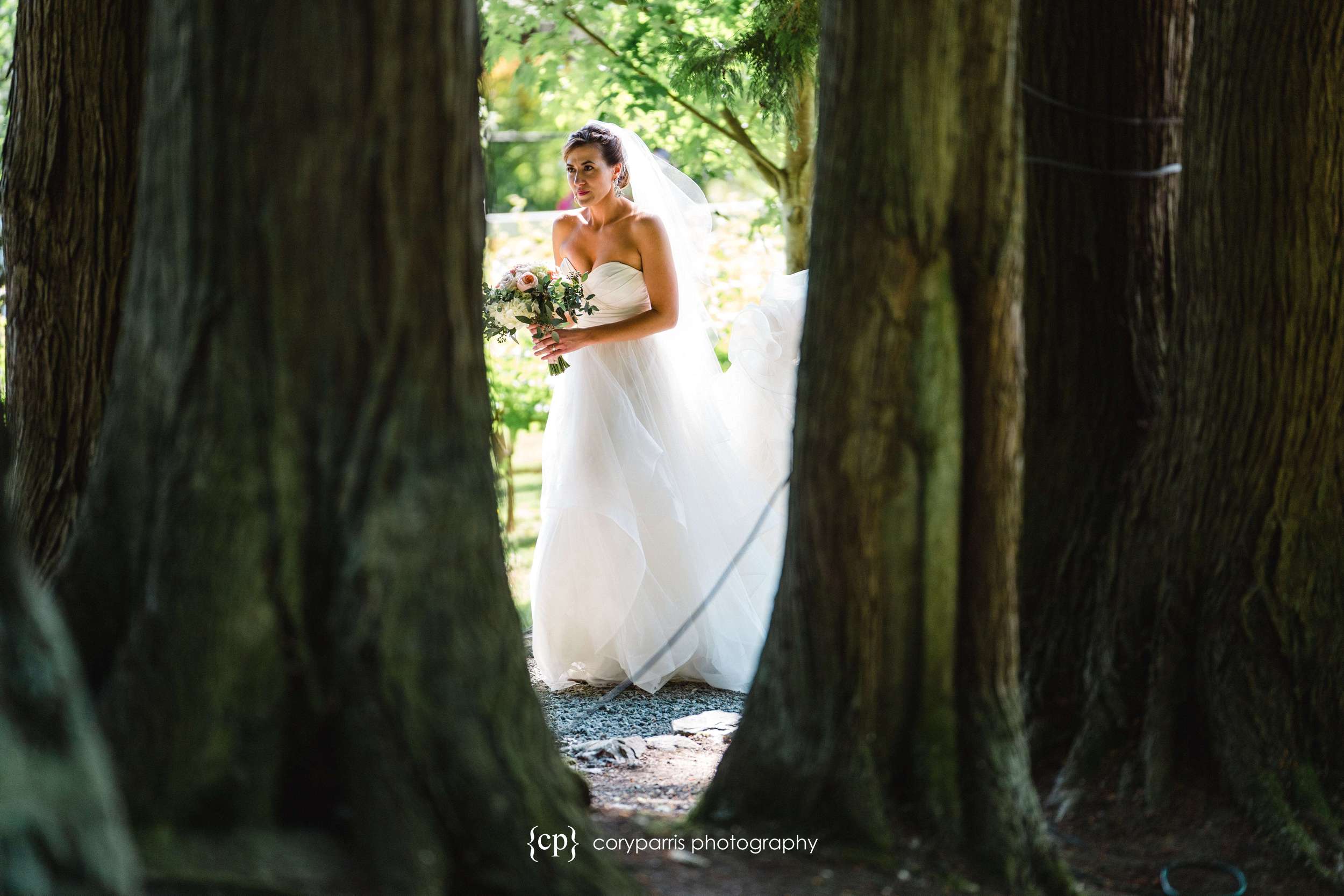 Ashley making her way through the trees to her wedding