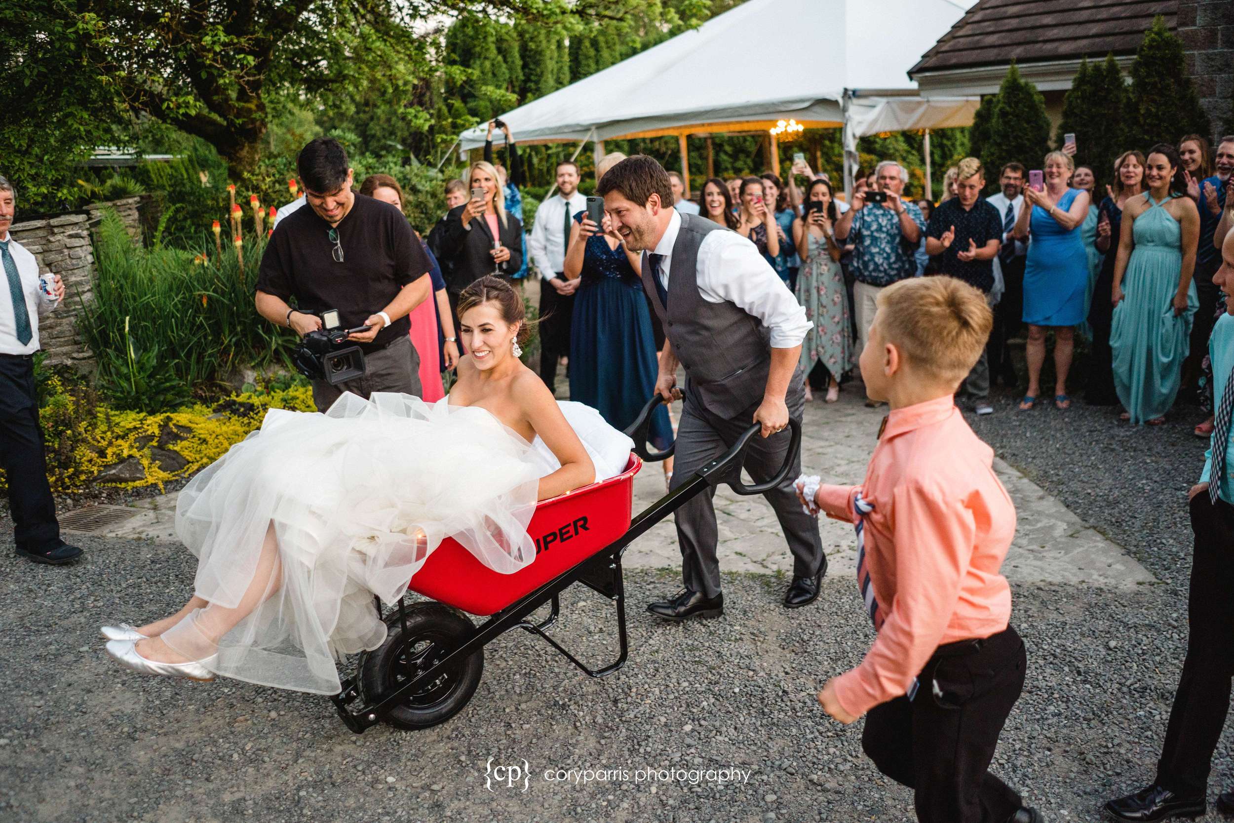 Bride in a wheelbarrow. Evidently a family tradition that I had not heard of before this wedding!