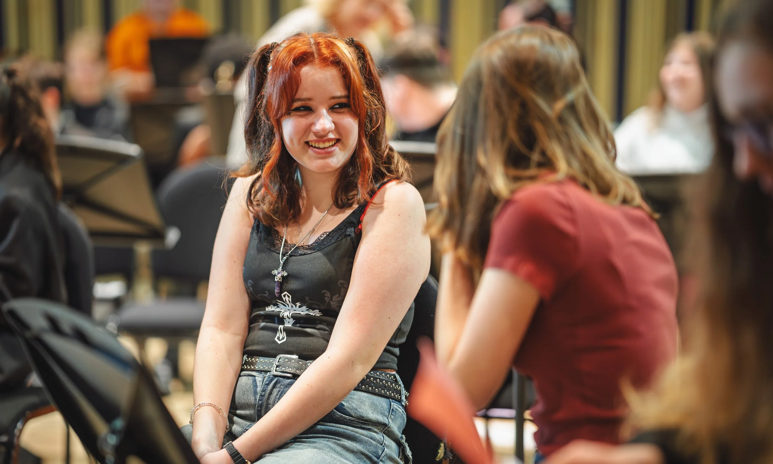 A Modulo musician and her friend are smiling during a rehearsal.
