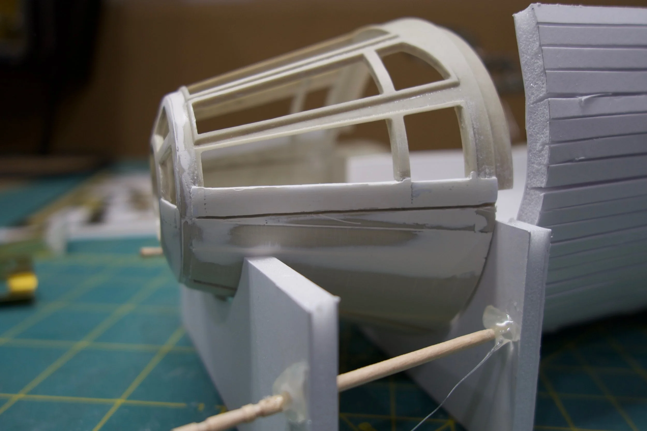 I used a bit of epoxy to start filling in the gaps and old panel lines, while slightly reinforcing the stacked styrene.