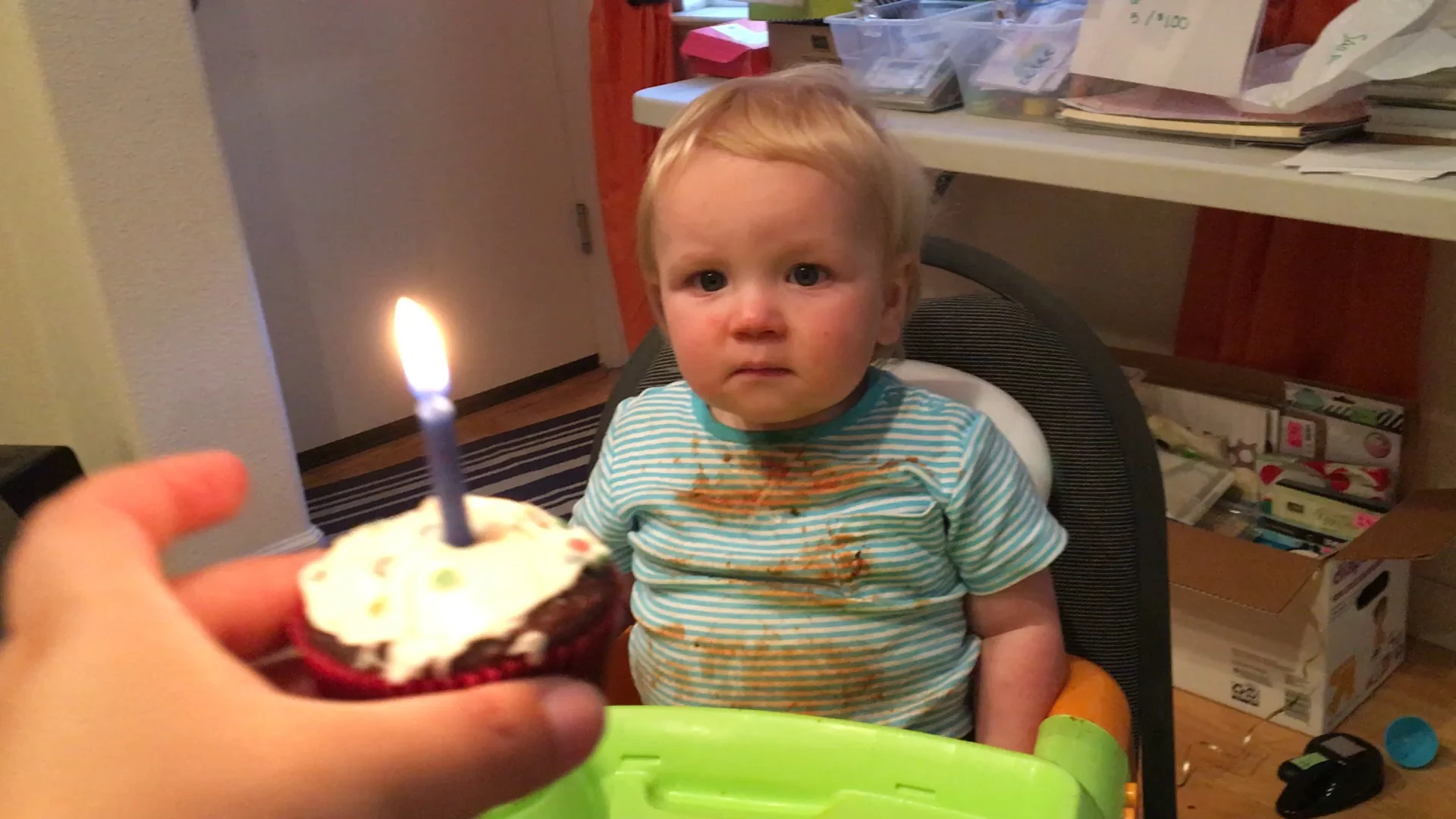 Not quite so sure about this candle thing... (Ignore the carnage that is his shirt after spaghetti night)