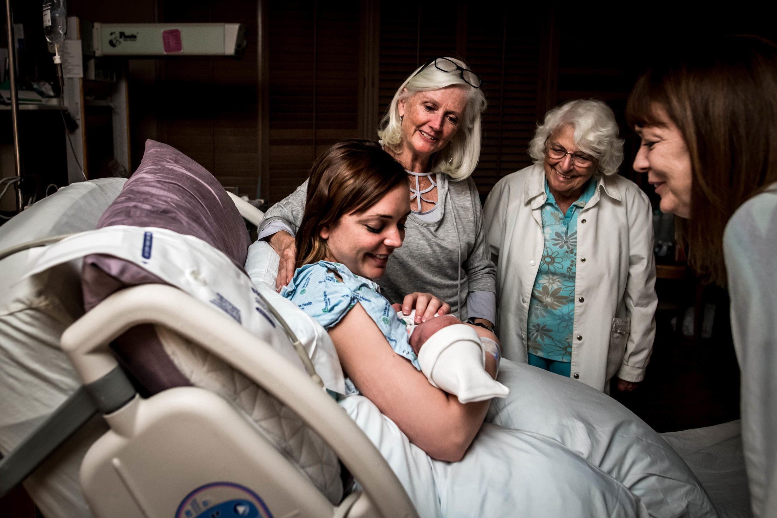 generations gather around to see newborn