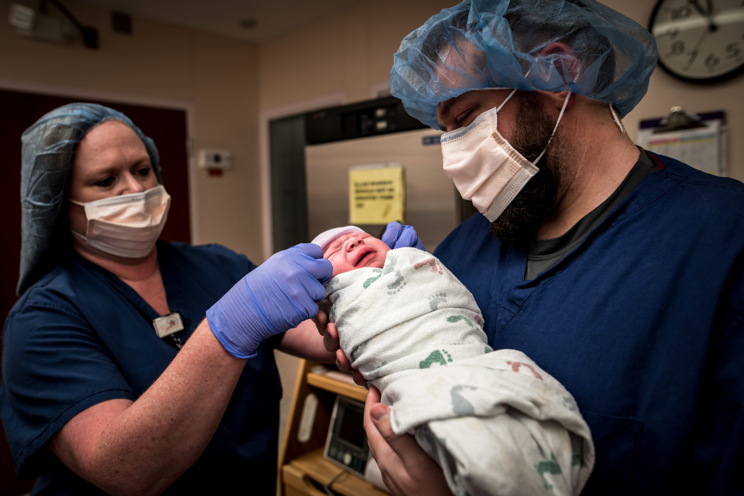 Dad admires his new son after a c-section birth