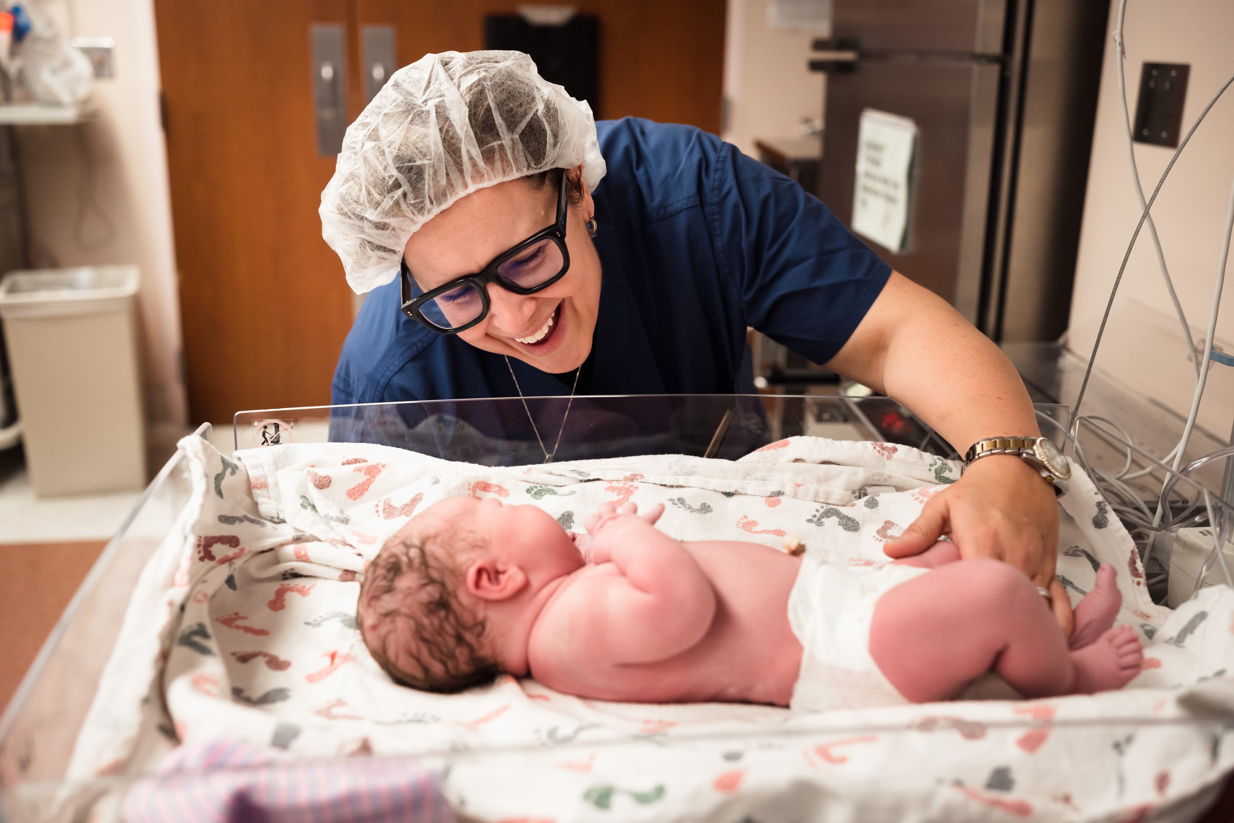 new parent smiles at newborn after family-centered cesarean birth at Dallas hospital