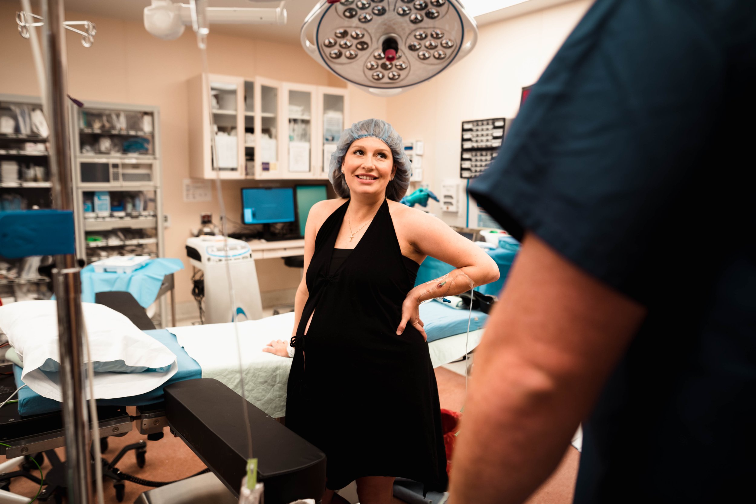 mother stands preparing for cesarean birth in Dallas hospital