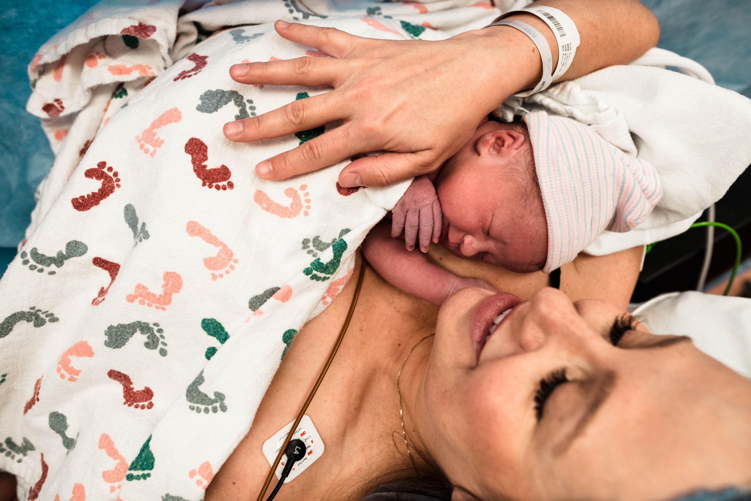 mother holds newborn close after c-section birth in Frisco hospital