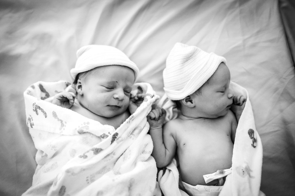 twin babies lay side by side after birth