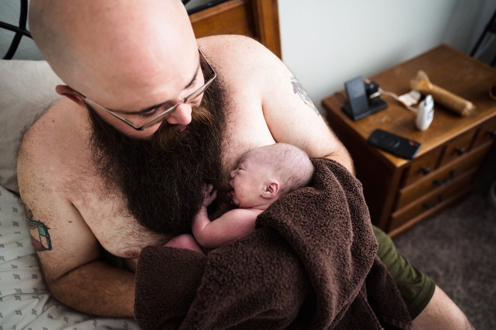 dad holds newborn after home birth Frisco, TX