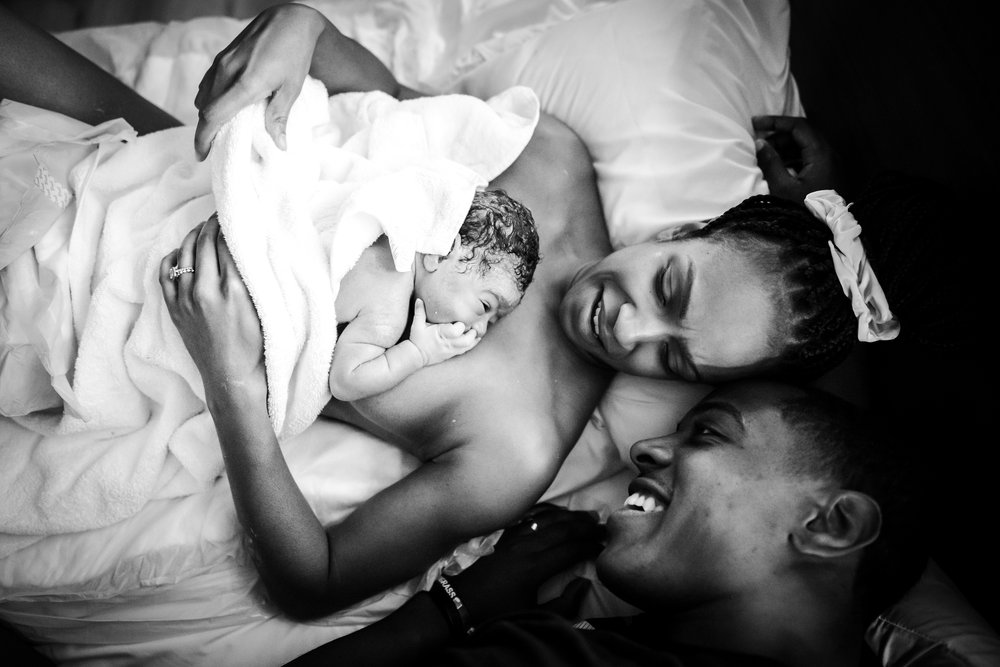 couple hold newborn after Dallas homebirth