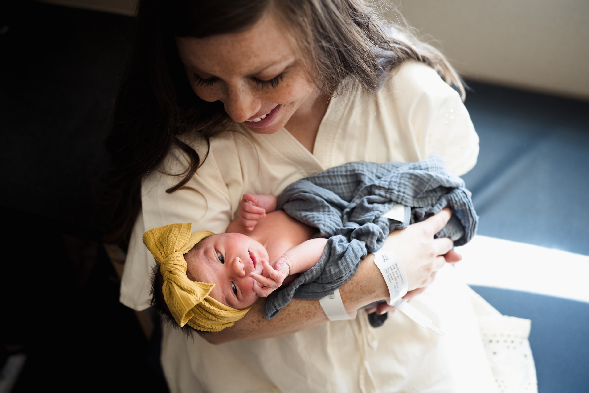 mother holds newborn baby girl in arms | Kathryn J birth Stories | Fresh 48 guide | Dallas birth photographer