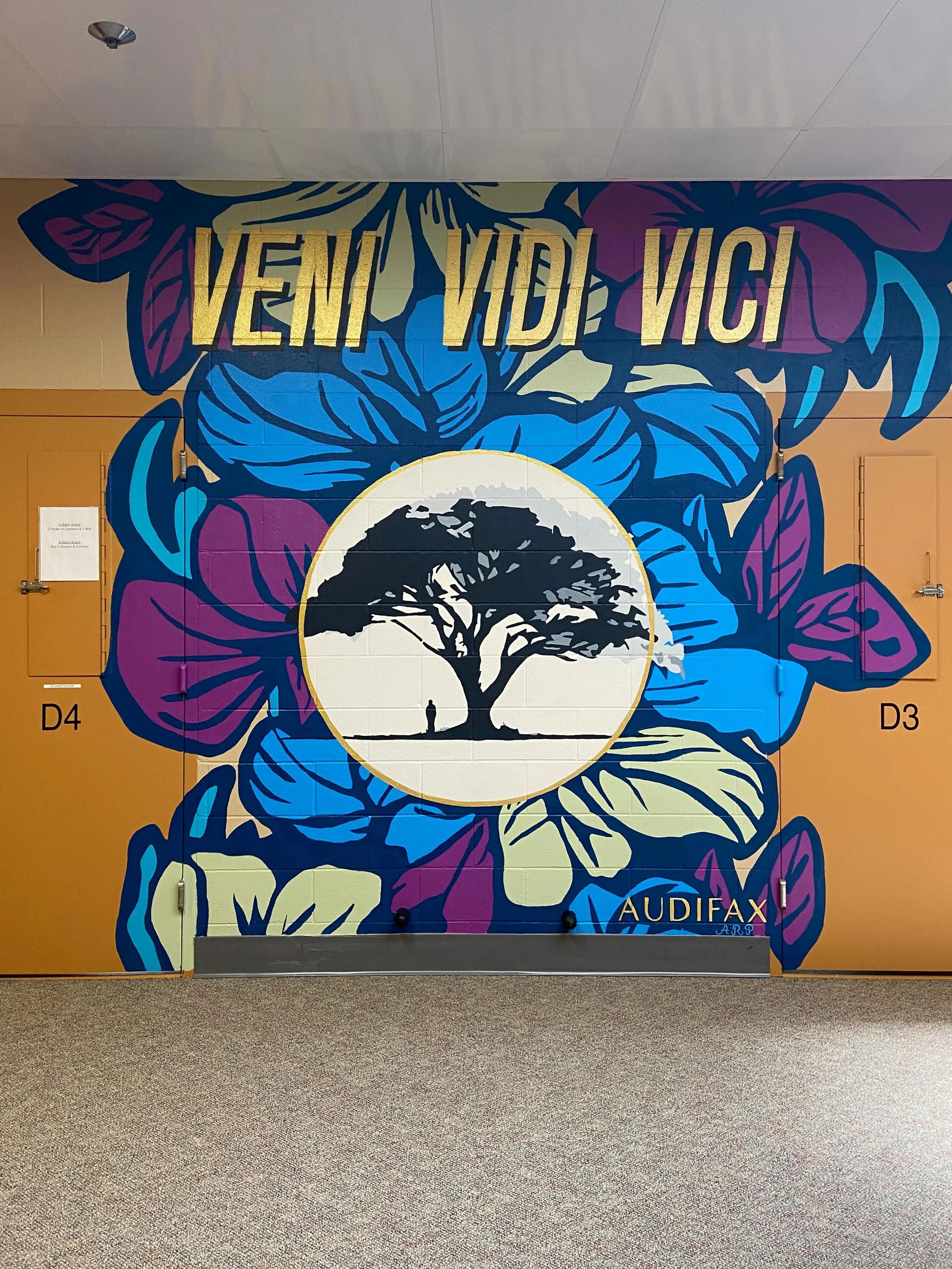 Designed and painted with the first ATTA Program (Assessment, Treatment, Transition, and Aftercare) Student in the Juvenile Detention Center, this mural represents growth, vibrancy and peace, with an intention of love and finding personal power from 