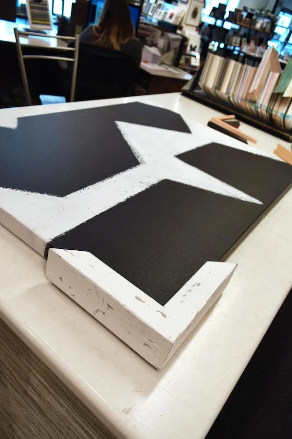 Back to the drawing board. A chunky, distressed white wood is the right size to add some drama and looks great. But it wasn’t enough of a change from the original look, which was also encased in white.