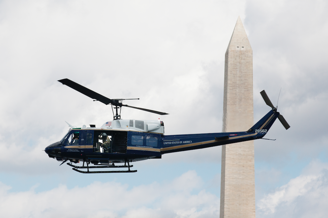 A specially painted UH-1N Huey Helicopter flown by the US Air Force passes the Washington Monument.