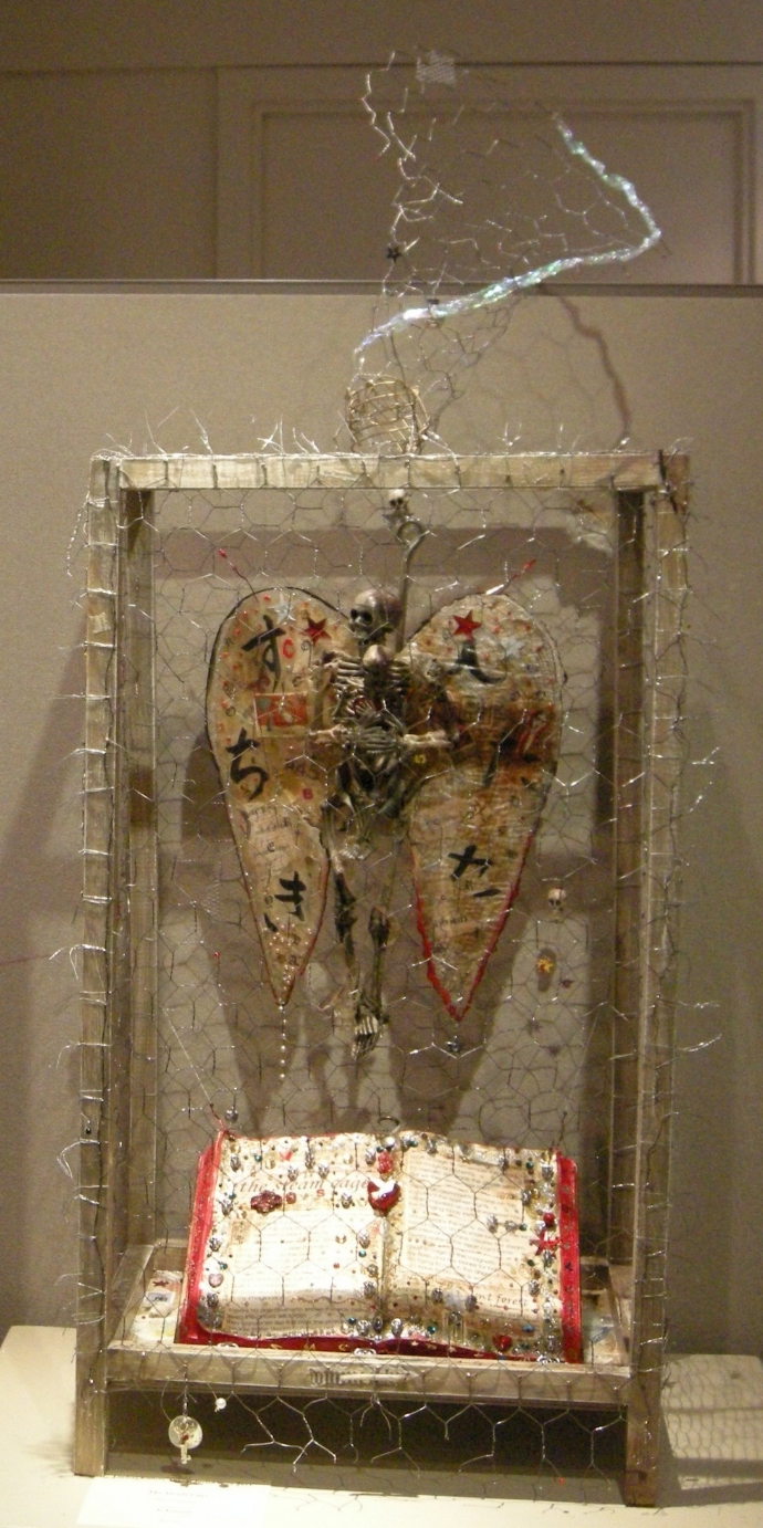 "the steam cage" - mixed-media collage, chicken wire, wood, plastic skeletons, found fiberglass wing, beads, book, shark hook, text. Lindsay Gallery 2011.