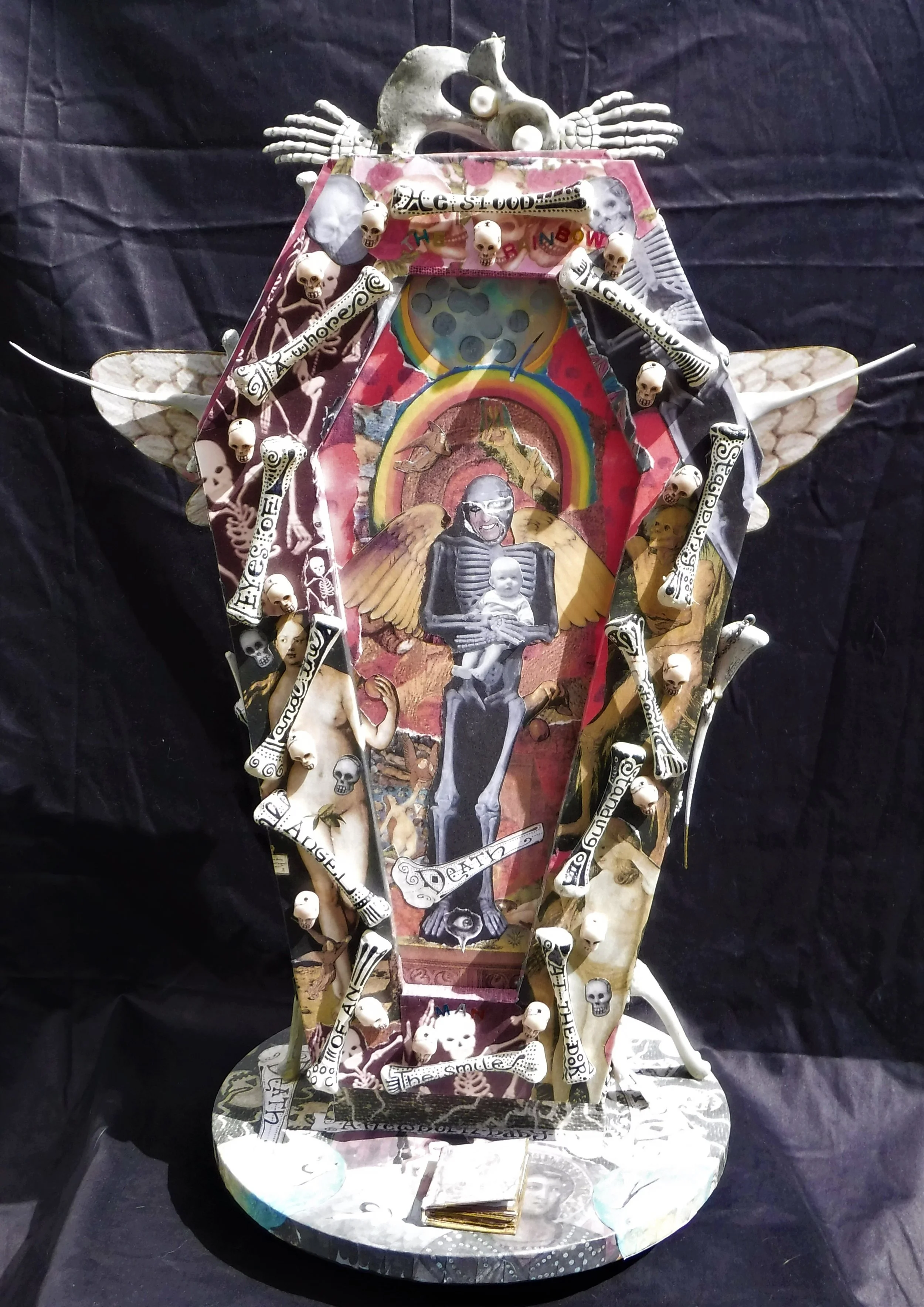 "the rainbow man" - mixed-media sculpture, wooden lazy susan base, foam core, chicken bones, beads, Alice Cooper/Marilyn Manson's face, photograph of my brother Howard as a baby, text.