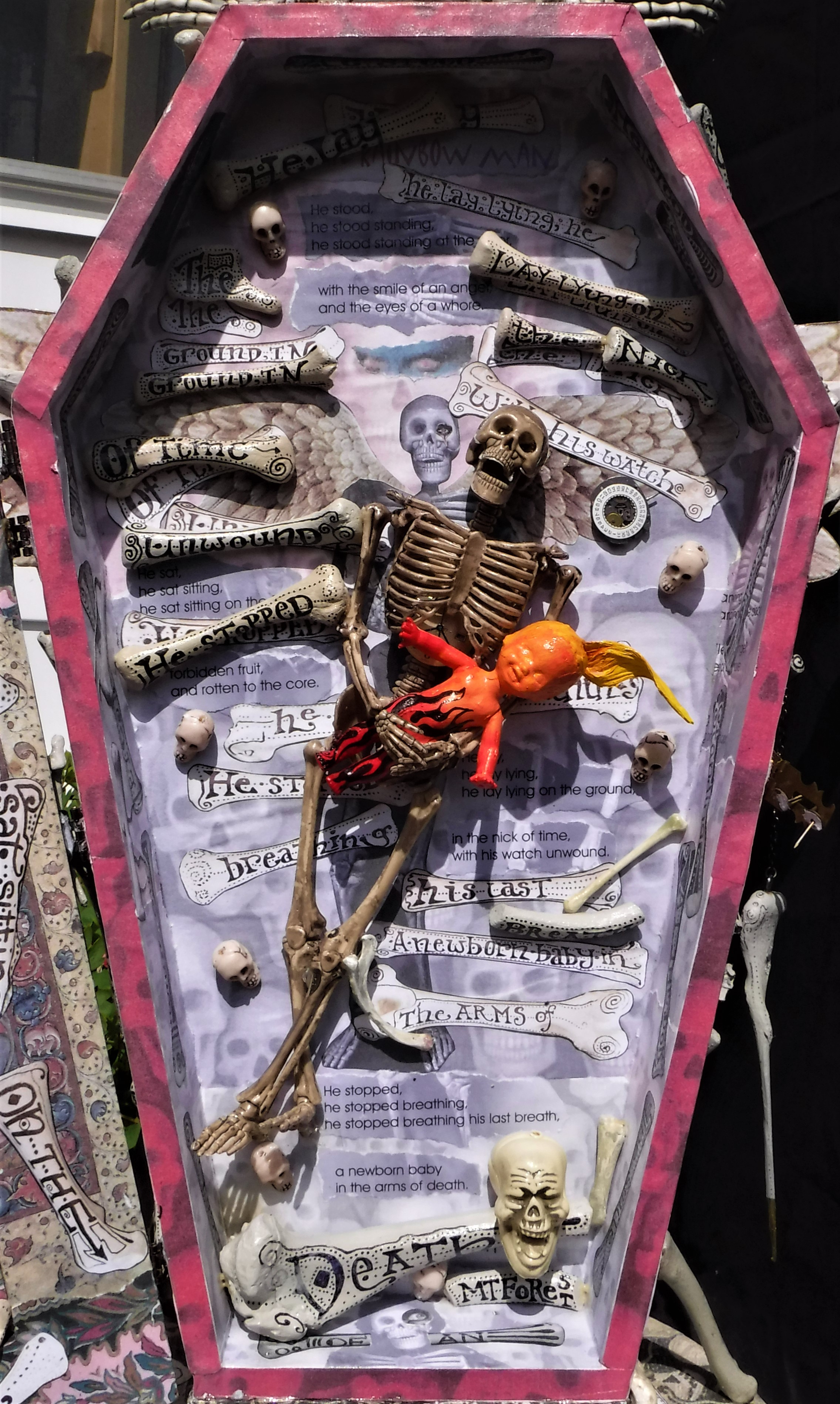 "the rainbow man" - interior, plastic dollar store skeleton, doll, acrylic paint, chicken bones, text.