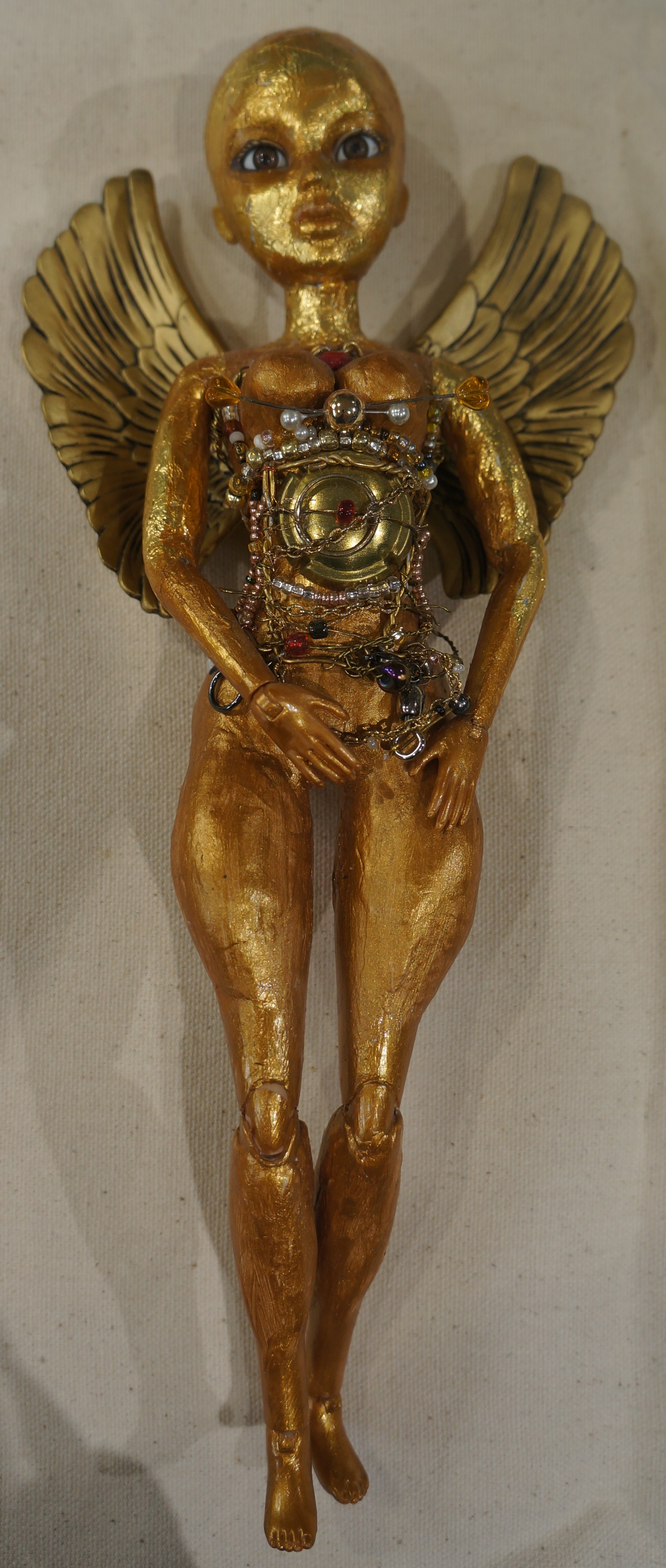 Altered doll. Air-dry clay, gold paint, beads, wire, found plastic wings, gold foil.